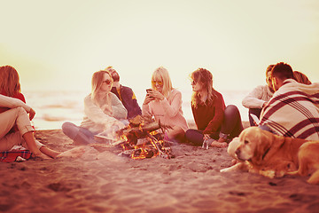 Image showing Friends having fun at beach on autumn day