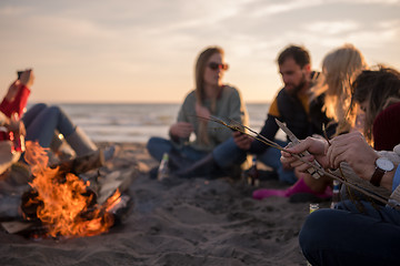 Image showing Friends having fun at beach on autumn day