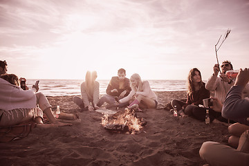 Image showing Friends having fun at beach on autumn day