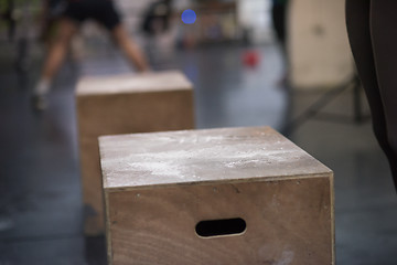 Image showing black woman is performing box jumps at gym