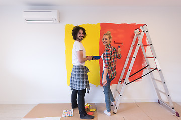 Image showing couple painting interior wall