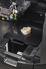 Image showing 3D Printer With Finished 3D Printed Dental Implant Bridge