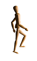 Image showing Wooden mannequin walking upstairs