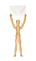 Image showing Wooden model dummy holding envelop