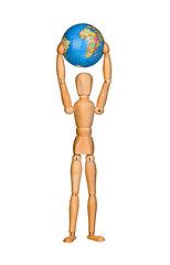 Image showing Wooden model dummy holding globe over head