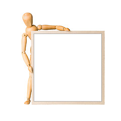 Image showing Wooden model dummy holding square cardboard frame