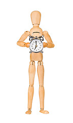 Image showing Wooden model dummy holding alarm-clock