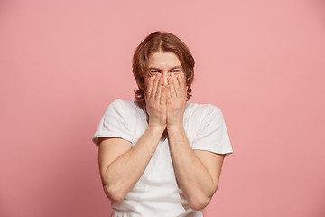 Image showing The happy business man standing and smiling against pink background.