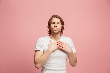 Image showing Portrait of the scared man on pink