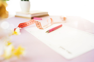 Image showing Notebook with pen, centimeter and paper on table