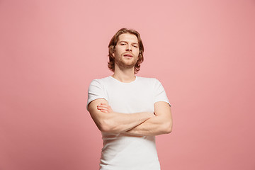 Image showing The happy business man standing and smiling against pink background.