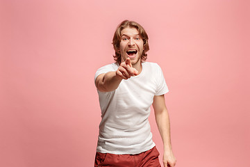 Image showing The happy business man point you and want you, half length closeup portrait on pink background.