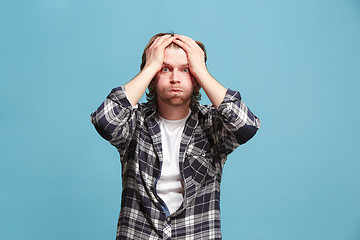 Image showing Beautiful man looking suprised and bewildered isolated on blue