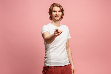 Image showing The happy business man point you and want you, half length closeup portrait on pink background.