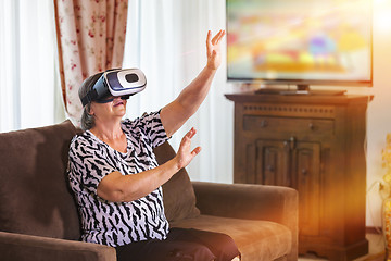 Image showing Senior woman with virtual headset or 3d glasses playing