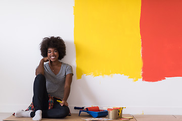 Image showing back female painter sitting on floor