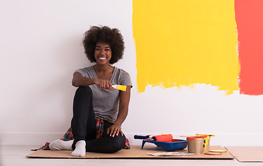 Image showing back female painter sitting on floor