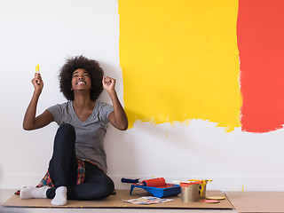 Image showing back female painter sitting on floor