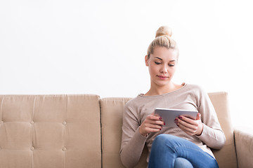 Image showing woman sitting on sofa with tablet computer