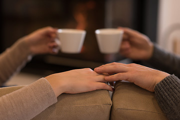 Image showing Young couple  in front of fireplace