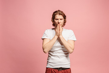 Image showing Beautiful man looking suprised and bewildered isolated on pink