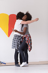 Image showing couple with painted heart on wall