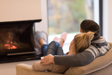 Image showing Young couple  in front of fireplace