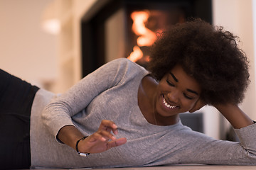 Image showing black women using tablet computer on the floor