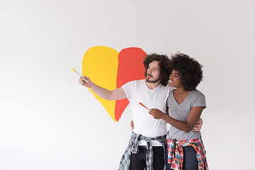 Image showing couple with painted heart on wall