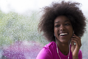 Image showing portrait of young afro american woman in gym while listening mus