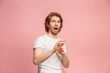 Image showing Portrait of the scared man on pink