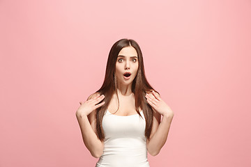 Image showing Beautiful woman looking suprised isolated on pink