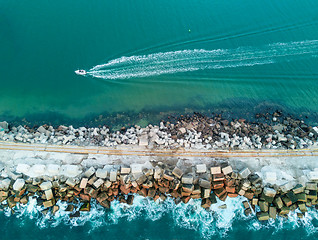 Image showing A speed boat and a breakwall aerial view