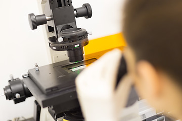 Image showing Life science researcher microscoping in genetic scientific laboratory.