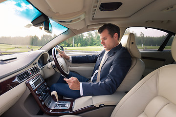 Image showing Man using cell phone while driving