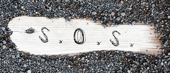 Image showing Sand on planked wood - SOS