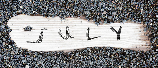 Image showing Sand on planked wood - July