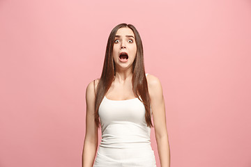 Image showing Portrait of the scared woman on pink