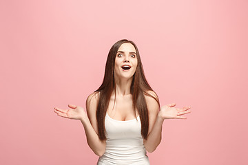 Image showing Beautiful woman looking suprised isolated on pink