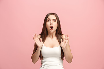 Image showing Beautiful woman looking suprised isolated on pink