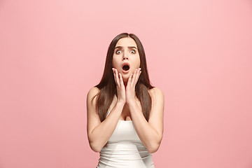 Image showing Beautiful woman looking suprised isolated on pink