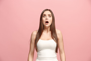 Image showing Portrait of the scared woman on pink