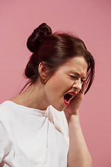 Image showing Woman having headache. Isolated over pink background.