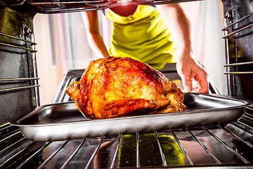 Image showing Cooking chicken in the oven at home.