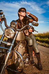 Image showing Biker girl sitting on motorcycle