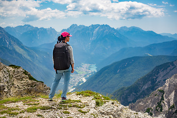 Image showing Hiker woman standing up achieving the top Dolomites Alps.