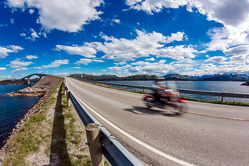 Image showing Biker rides a road with Atlantic Ocean Road in Norway.
