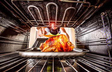 Image showing Cooking chicken in the oven at home.