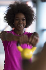 Image showing woman working out in a crossfit gym with dumbbells