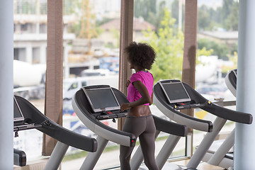 Image showing afro american woman running on a treadmill